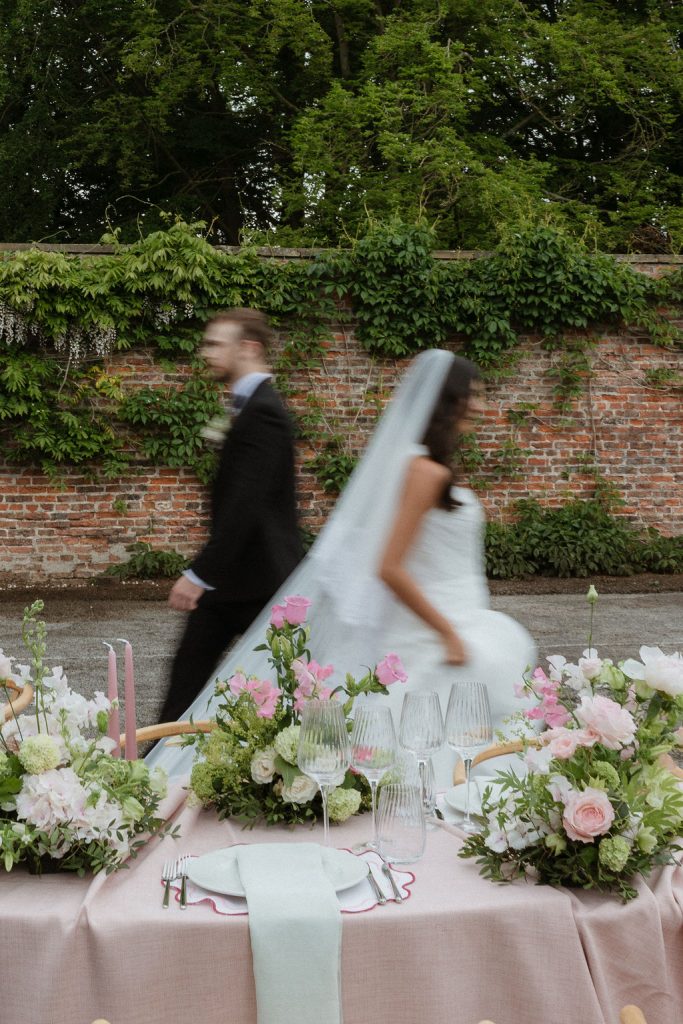 14-tier sculptural wedding cake at Saltmarshe Hall surrounded by blush and ivory wedding flowers
