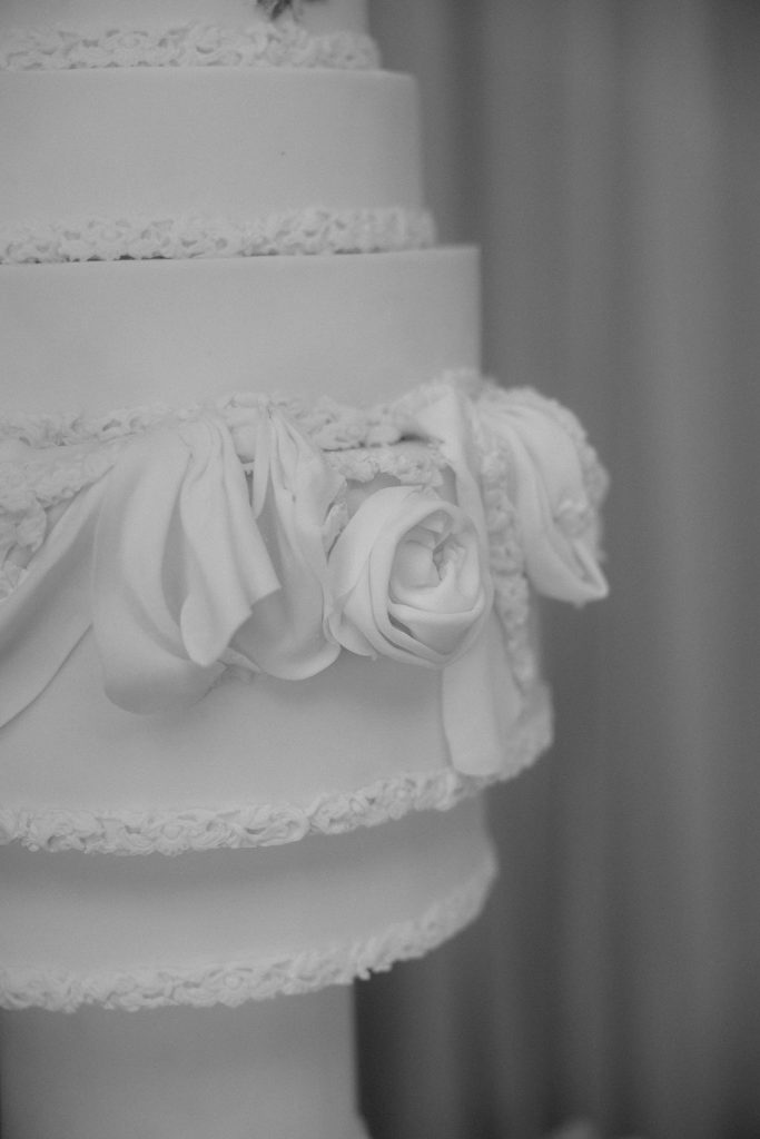 14-tier sculptural wedding cake at Saltmarshe Hall surrounded by blush and ivory wedding flowers
