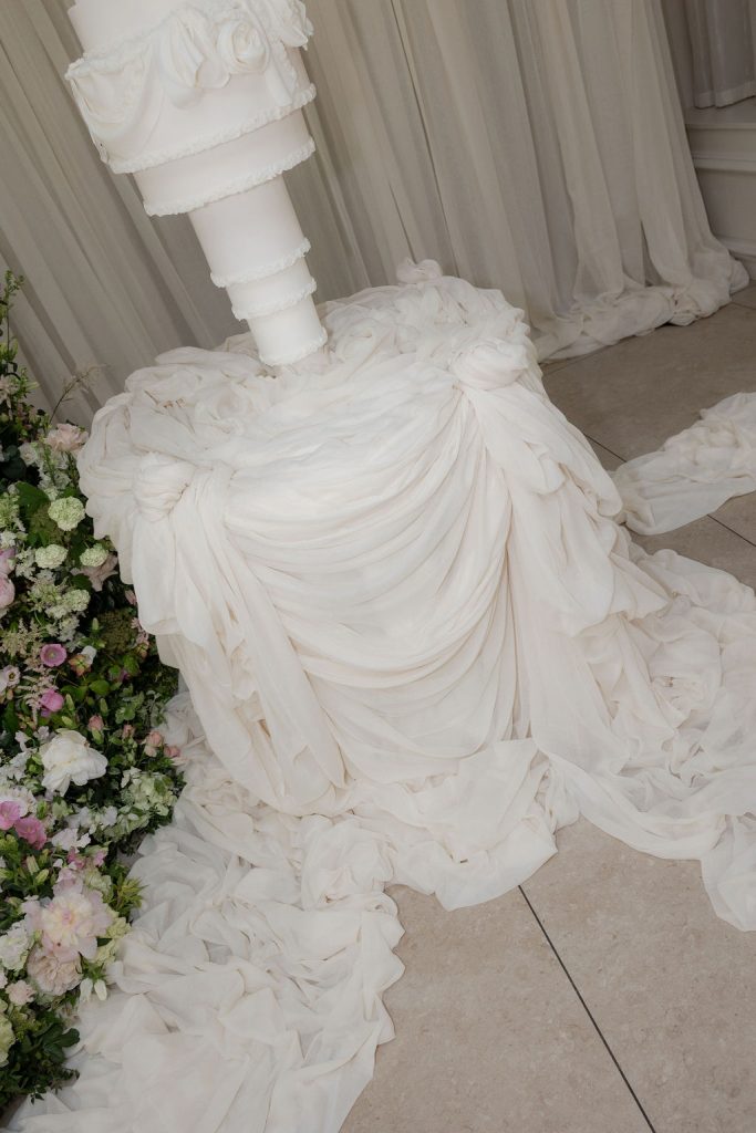14-tier sculptural wedding cake at Saltmarshe Hall surrounded by blush and ivory wedding flowers