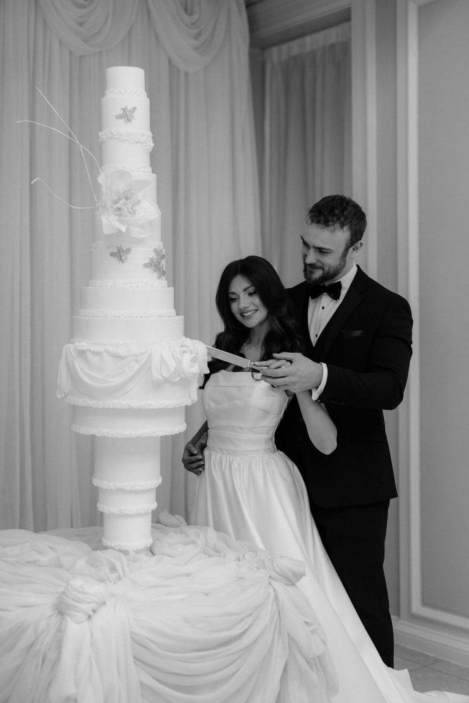 14-tier sculptural wedding cake at Saltmarshe Hall surrounded by blush and ivory wedding flowers