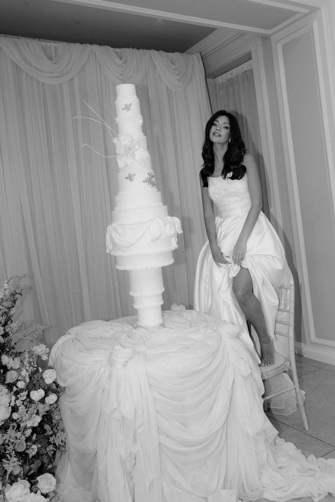 14-tier sculptural wedding cake at Saltmarshe Hall surrounded by blush and ivory wedding flowers